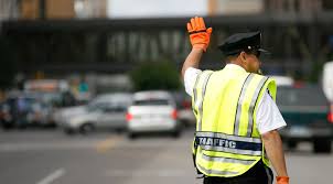 <p>If a police officer is directing traffic at an intersection, you should:</p>