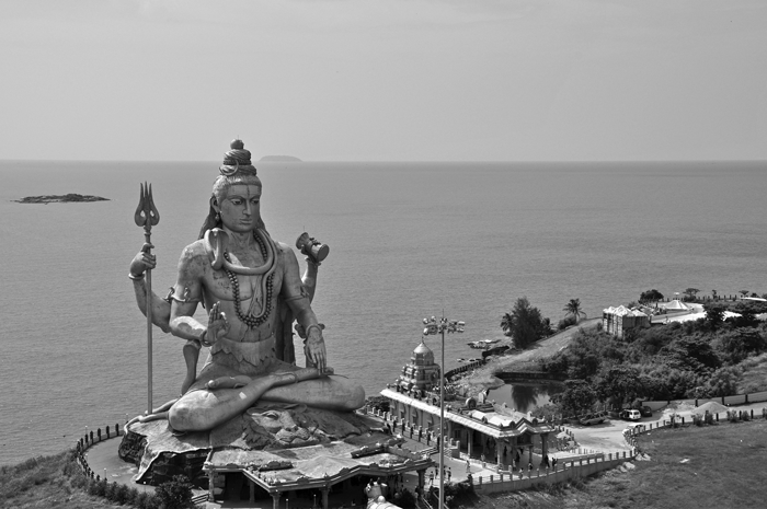 <p>Comparing both photographs, each image shows the significance of temples, religious statuary, and iconography on the</p>