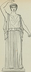 Simple, made of wool. Went to the knees on young men and to the ankle for others, floor length for women. Fastened at one shoulder, sometimes two. Belted at the waist.