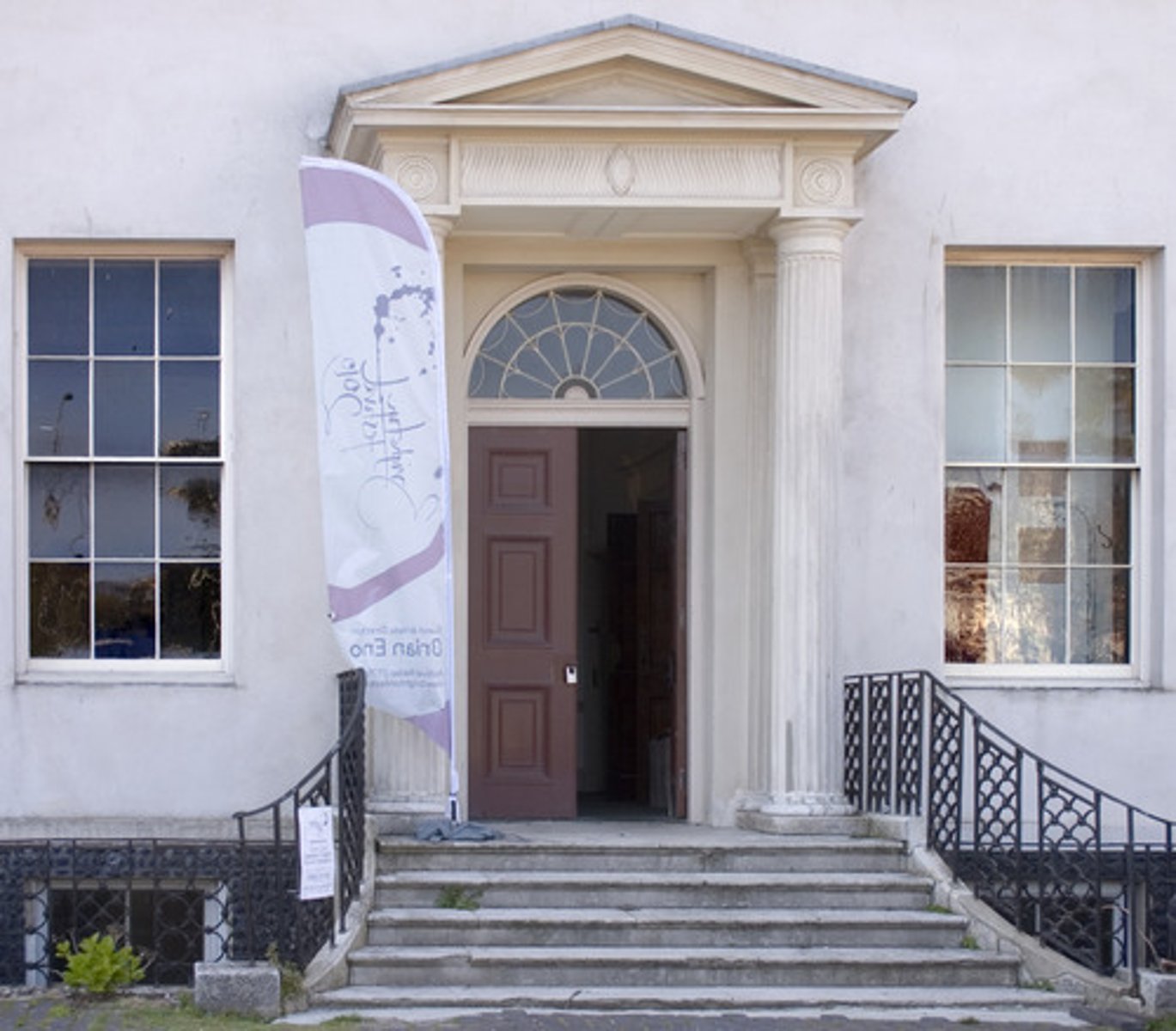 <p>a porch or entrance to a building consisting of a covered and often columned area</p>