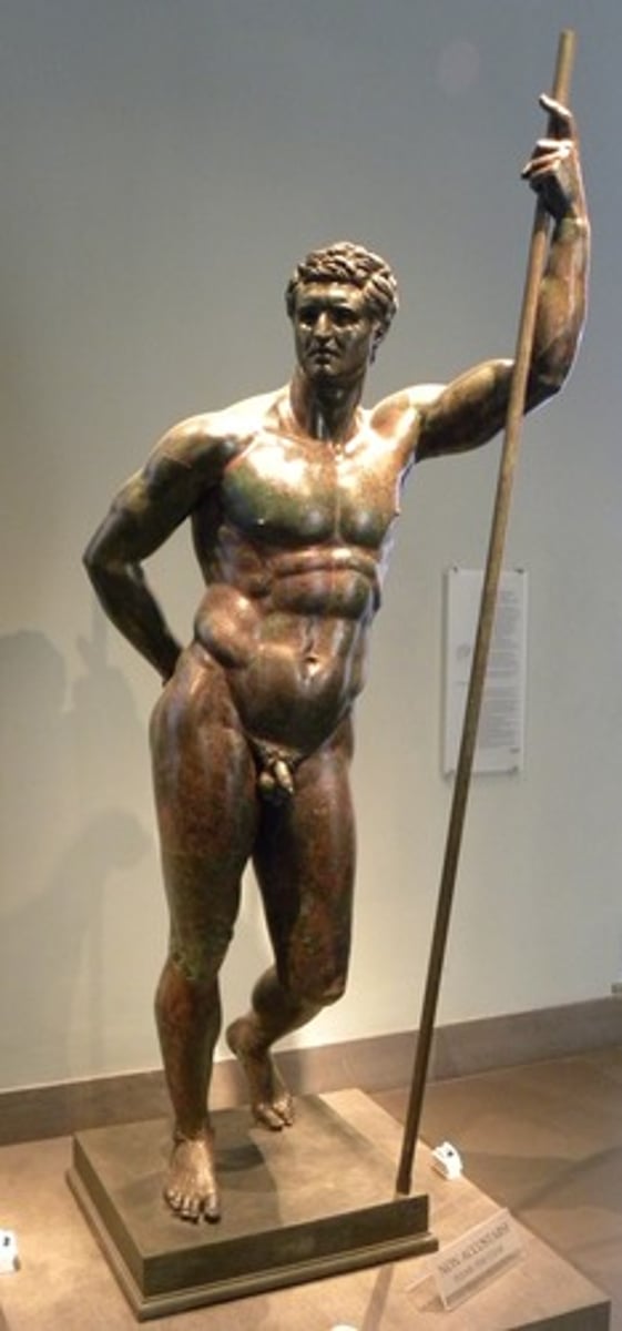 <p>- <span class="bgP">150 bce (high/late hellenistic pd)</span></p><p>- <span class="bgP">found in Roman house on the Esquiline (italy)</span></p><p>- bronze original</p><p>- depicts young hellenistic ruler with heavy and over-muscular body</p><p>- has thin/short beard depicted by carvings in the face</p>