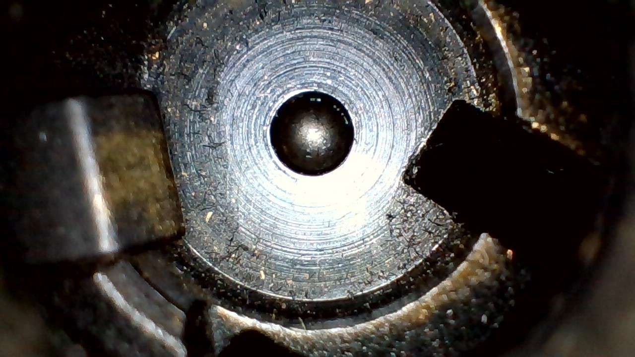 <p>What type of machining likely left these concentric rings on this bolt breechface?</p>