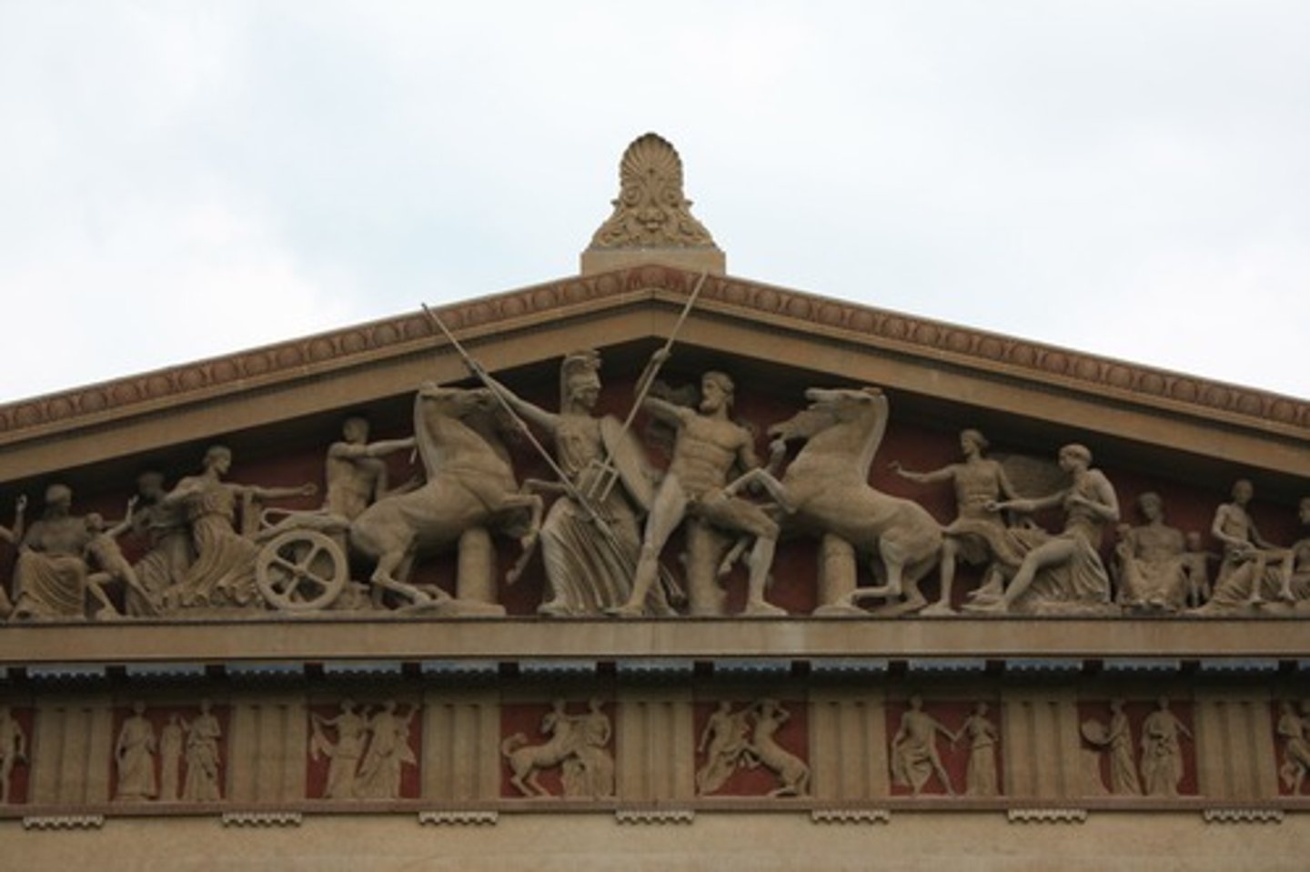 <p>a broad horizontal band of sculpted or painted decoration, especially on a wall near the ceiling.</p>