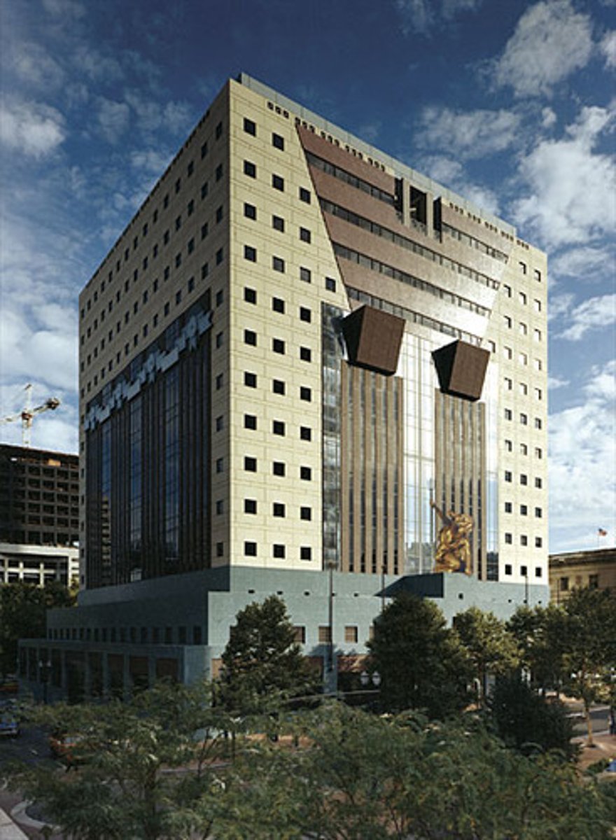 <p>The blocky edifice designed by Michael Graves is dominated by highly abstracted classical elements - including columns, pediments, and a frieze-like decorative band - all set amid a grid of small square windows. A teal-coloured podium encompasses the entrance level, and features a Classically-styled sculpture of a woman called Portlandia, by artist Raymond Kaskey, above the front doors.</p>