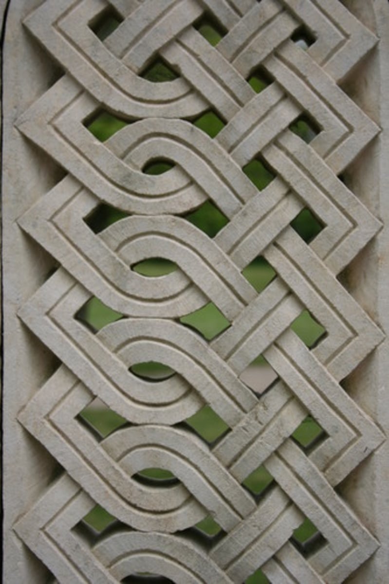 <p>A decorative pattern formed by intertwining bands or ribbon-like forms that weave over and under one another, creating elaborate knot-like patterns, popular in early medieval art.</p>