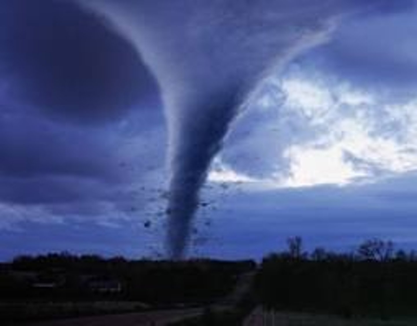 <p>A rapidly whirling, funnel-shaped cloud that reaches down to touch Earth's surface.</p>