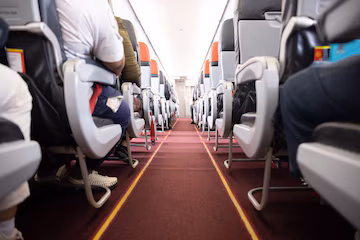 a passageway between rows of seats