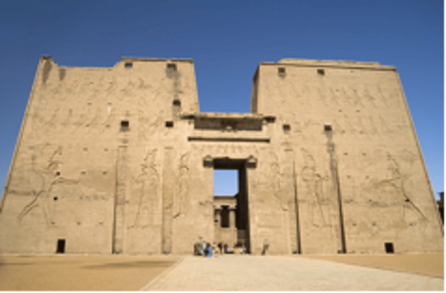 <p>The wide entrance gateway of an Egyptian temple, characterized by its sloping walls</p>