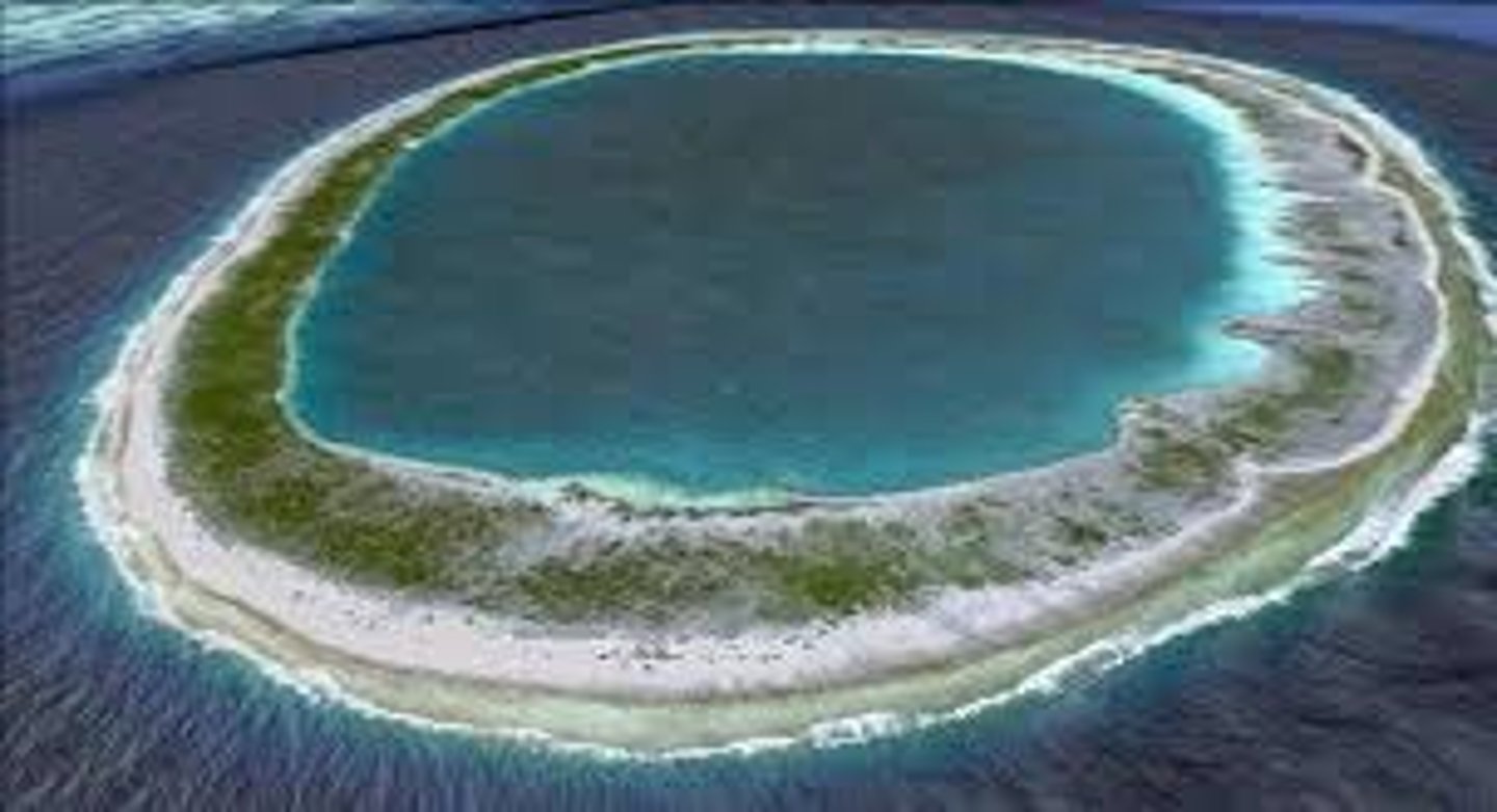 <p>A ring-shaped coral reef encircling a lagoon where a volcanic island used to be</p>