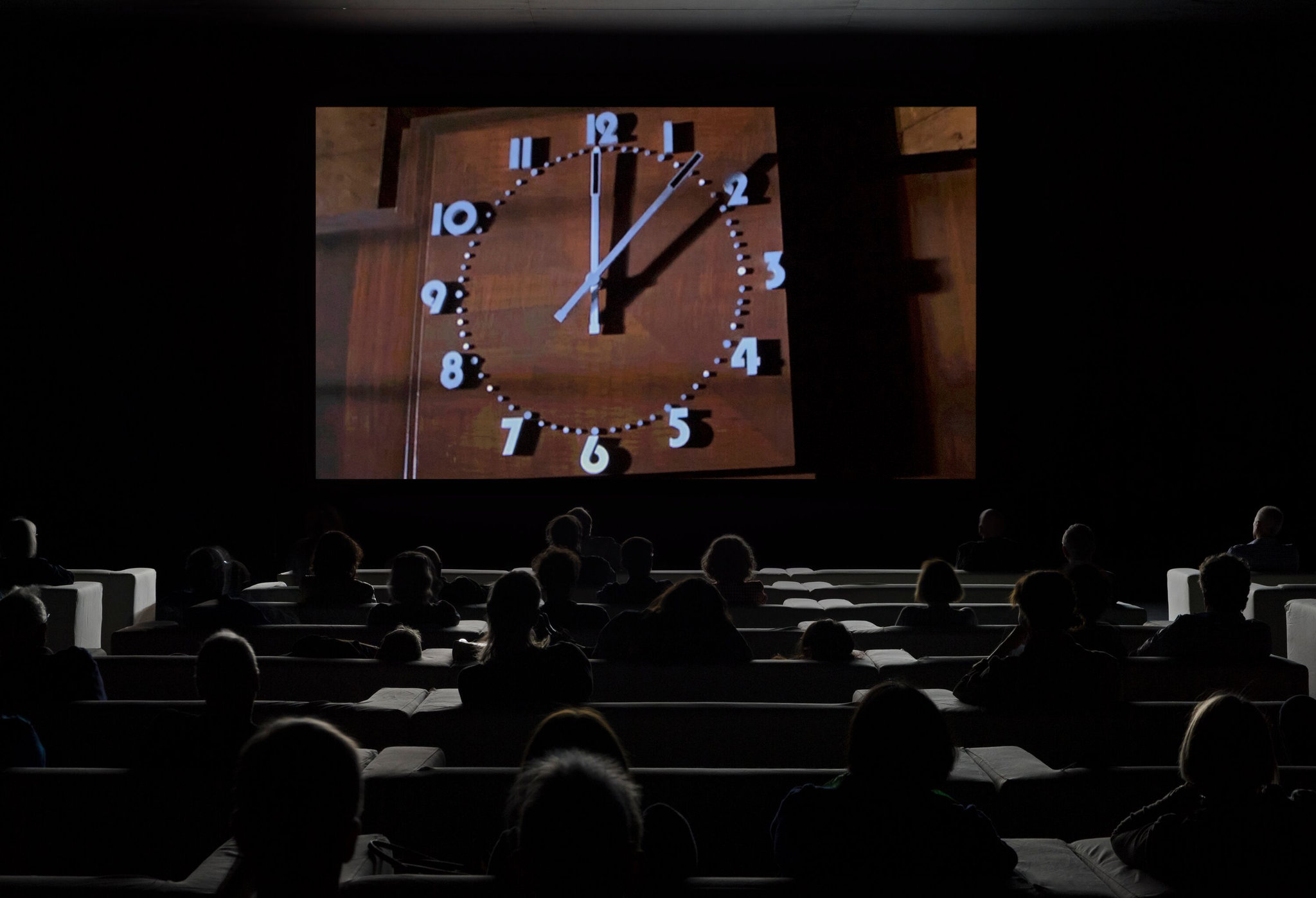 <p>Title: The Clock</p><p>Time: 2010</p><p>Known for:</p><ul><li><p class=""><strong>24-hour video montage</strong> composed of thousands of film clips showing clocks or references to time</p></li><li><p class=""><strong>Synchronizes with real time</strong>—viewers can literally “watch” time pass</p></li><li><p class="">Explores our <strong>perception of time</strong>, <strong>cinematic memory</strong>, and <strong>collective experience</strong>, blurring the line between narrative and reality by transforming timekeeping into both a functional tool and an immersive, meditative artwork.</p></li></ul><p></p>