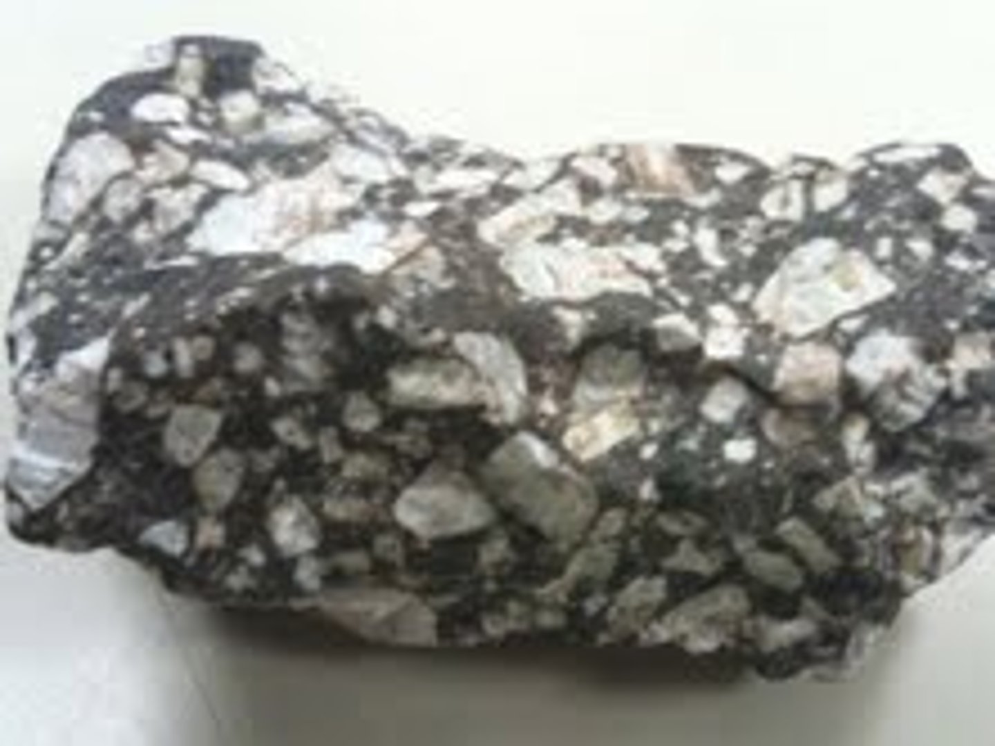 <p>F,I,M,UM: Intermediate<br>Texture: Porphyritic<br>Mineral composition: andesine and one or more mafic constituents<br>Other properties: large and small crystals. Color can be gray with white to light gray phenocrysts.<br>Inferred rock origin: Extrusive; violent volcanic eruption. The fine-grained version (?) of diorite.</p>