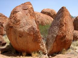 The breaking down of rocks and other materials on the Earth's surface.