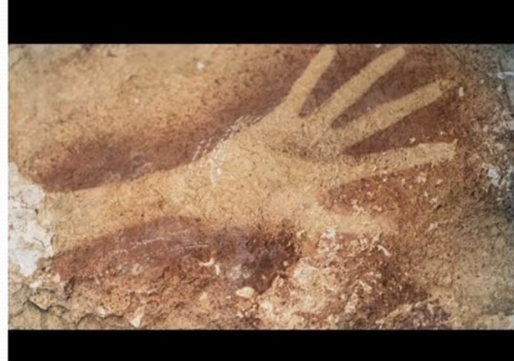 <p>art from 40,000 years ago in Leang Timpuseng Cave, Sulawesi island, Indonesia. in it there is painting of a female pig-deer (babirusa) and the oldest hand stencil</p>