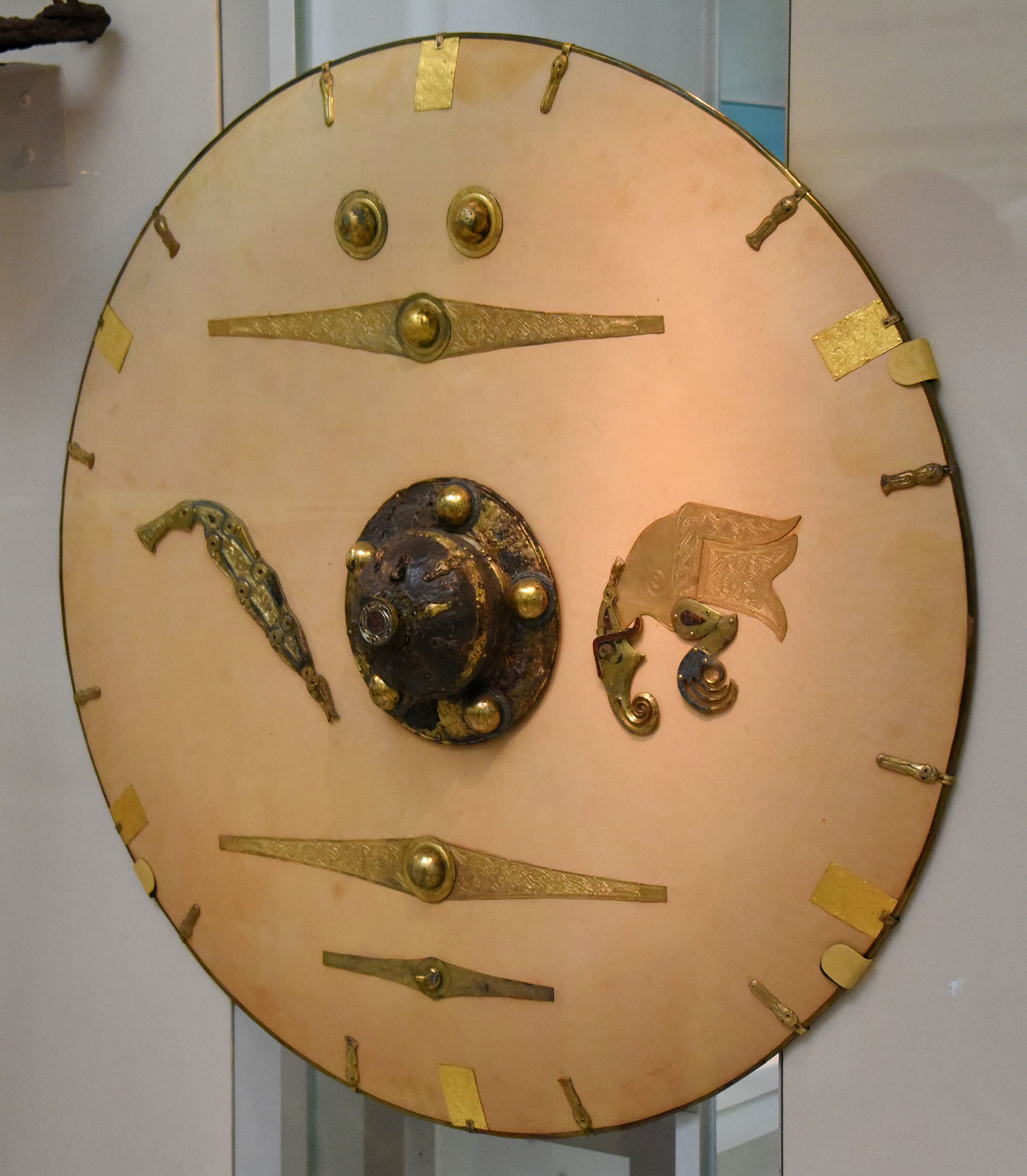 Shield (reconstruction) with bird and dragon fittings, Anglo-Saxon, early 7th century from Mound 1, Sutton Hoo, Suffolk, England, gold, copper alloy, garnet, cloisonné