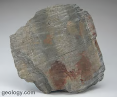 <p>micas are dominant minerals, finely foliated, splits easily, silky sheen.</p>