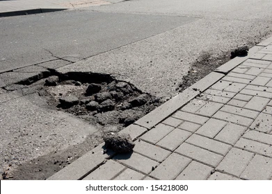 <p>a depressed or broken part of a slab resulting from pavement cracking and disintegration of concrete</p>