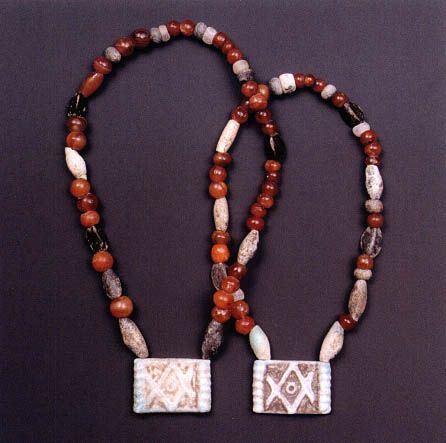 <p><strong><u>Date</u></strong> : 16th century BC<br></p><p><strong><u>Location</u></strong> : Grave Circle B, Mycenae </p><p></p><p><strong><u>Material</u></strong> : beads, ivory </p><p></p><p><strong><u>Significance</u></strong> : </p><ul><li><p>evidence of <strong>burial customs</strong> - <strong>jewellery</strong> either being <strong>worn</strong> <strong>or</strong> <strong>buried with</strong>, possibly as a <strong>gift</strong> ?</p></li><li><p>good craftsmanship - <strong>mould </strong>and <strong>carve beads</strong>, <strong>ivory</strong> into small pieces. </p></li><li><p>evidence of <strong>trade</strong> - <strong>ivory from Africa</strong>  </p></li></ul><p></p>