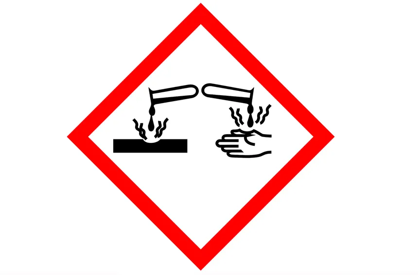 <p>Liquid pouring from test tube onto hand (and metal object)</p>