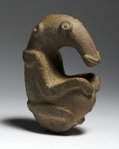 <p>Location: Ambum Valley, Enga Provine, Papua New Guinea Artist: N/A Date: c. 1,500 B.C.E Culture: (probably) ancient Oceania Period/Style: Prehistoric, Neolithic Medium/Material: Greywacke Theme(s): Birds, pestle Form: Made out of greywacke, probably to get a rich, brown color to represent the importance of animals. Function: Considered sacred and credited with supernatural powers by present day people of the region. Content: A bird-like figure that sits like a human calmly. Context: It has a higher level of figurative qualities than other pestles and may be in a unique class of its own.</p>