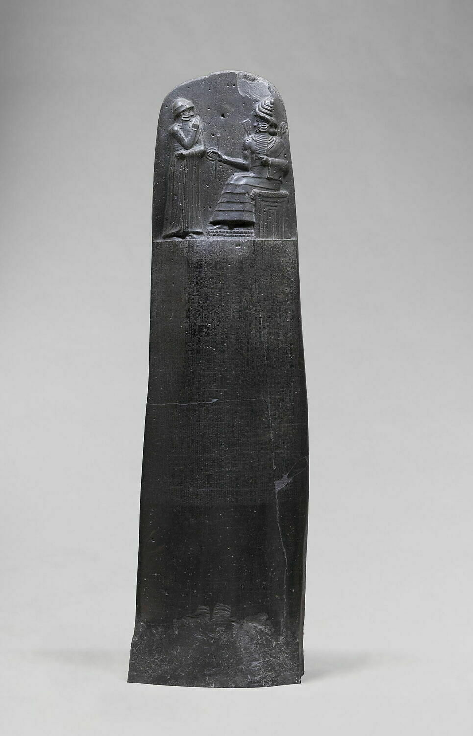 <p>A Babylonian legal text dating to around 1754 BCE, inscribed on a stele and featuring a comprehensive set of laws governing various aspects of society, emphasizing justice and the principle of retributive justice, famously beginning with the phrase "an eye for an eye. Basalt. Hierarchy of Scale. Depicts Hammurabi receiving divine right to rule from gods. </p>