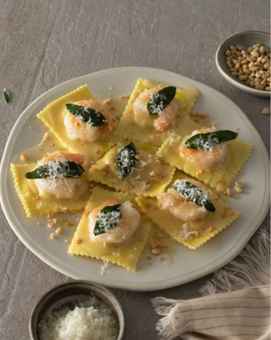 <p><span>Ravioli filled with creamy mascarpone and velvety butternut squash, Sauteed Prawns (Sustainably Harvested), Truffle Beurre Blanc, Grana Padano Parmesan Cheese, Toasted Pine Nuts, Amaretti Cookie, Crispy Fried Sage</span></p><p><span><em>Delicious, rich and incredibly addictive</em></span></p><p></p>