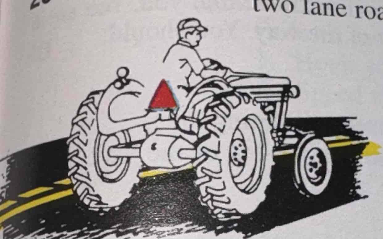 <p>You are following the slow-moving vehicle in the picture on a two-lane road. You may:</p>