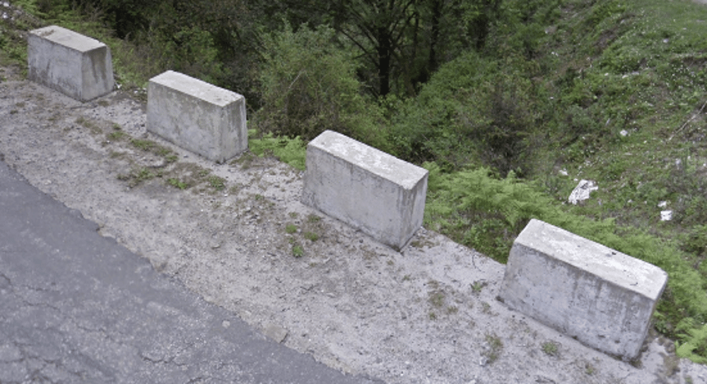 <p>Stone blocks guardrail on rural roads</p>