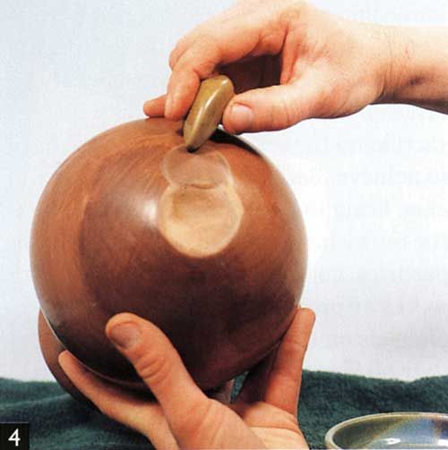 <p>a method of producing a luster on an unfired clay surface by rubbing it while leather-hard with a hard, smooth object to compact and align the surface particles</p>