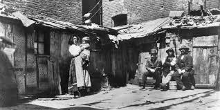 <p>Urbanization and industrialization worked together, cities provided both labor for factories as well as a market for their goods.The shift from rural to urban became increasingly apparent over the decades, by 1900 40% of American lived in towns or cities while in 1920, for the first time, more American would live in urban areas. People moving to cities included both immigrants and native Americans moving from rural areas. In the late 19th century, millions of young Americans would move to urban areas to look for new economic opportunities, leaving farms for industrial and commercial jobs. Joining among these internal migrants were African Americans from the South. Between the years of 1897 and 1930, nearly 1 million Black Southerners would move to either Western or Northern cities. Cities changed dramatically, growing as well as structurally changing. Mass transportation segregated cities by income, upper and middle class families moving away from the district centers to streetcar suburbs (communities that used transit routes) in order to escape the pollution, poverty, and crime. The leaving of higher-income classes left older sections to the working poor, most were immigrants. The differences in the areas of the cities contributed to the social-economic divisions of the time. When the poor moved into the business districts, landlords divided their inner-city housing into small, windowless rooms in order to increase profit. The tenement apartments and slums would cram 4,000 people into a single city block. In 1879, the City of New York would pass a law the required each bedroom to have a window. Landlords responded to the law by building cheap dumbbell tenements, buildings with open ventilation shafts in the center to provide a window for each room. However, the overcrowding and overall poor conditions lead to the rapid spread of deadly diseases, such as cholera, typhoid, and tuberculosis. In their crowded tenement parts, immigrant groups created ethnic neighborhoods where each group could maintain their culture. Many groups would even support their own newspapers or schools. Even though they were often crowded, unhealthy, and crime ridden, these neighborhoods (sometimes called “ghettos”) would serve as a foundation for hard-working immigrants and their children to achieve the American dream. The explosive amount of immigration in the US after 1865 renewed the populist protest to reduce the number of immigrants from the past, especially ones that differed from ethnicity, language, and religion from “old” immigrants. The efforts to discourage or restrict “new” immigrants caused earlier opposition to Irish, Italian, and Chinese migrants.</p>