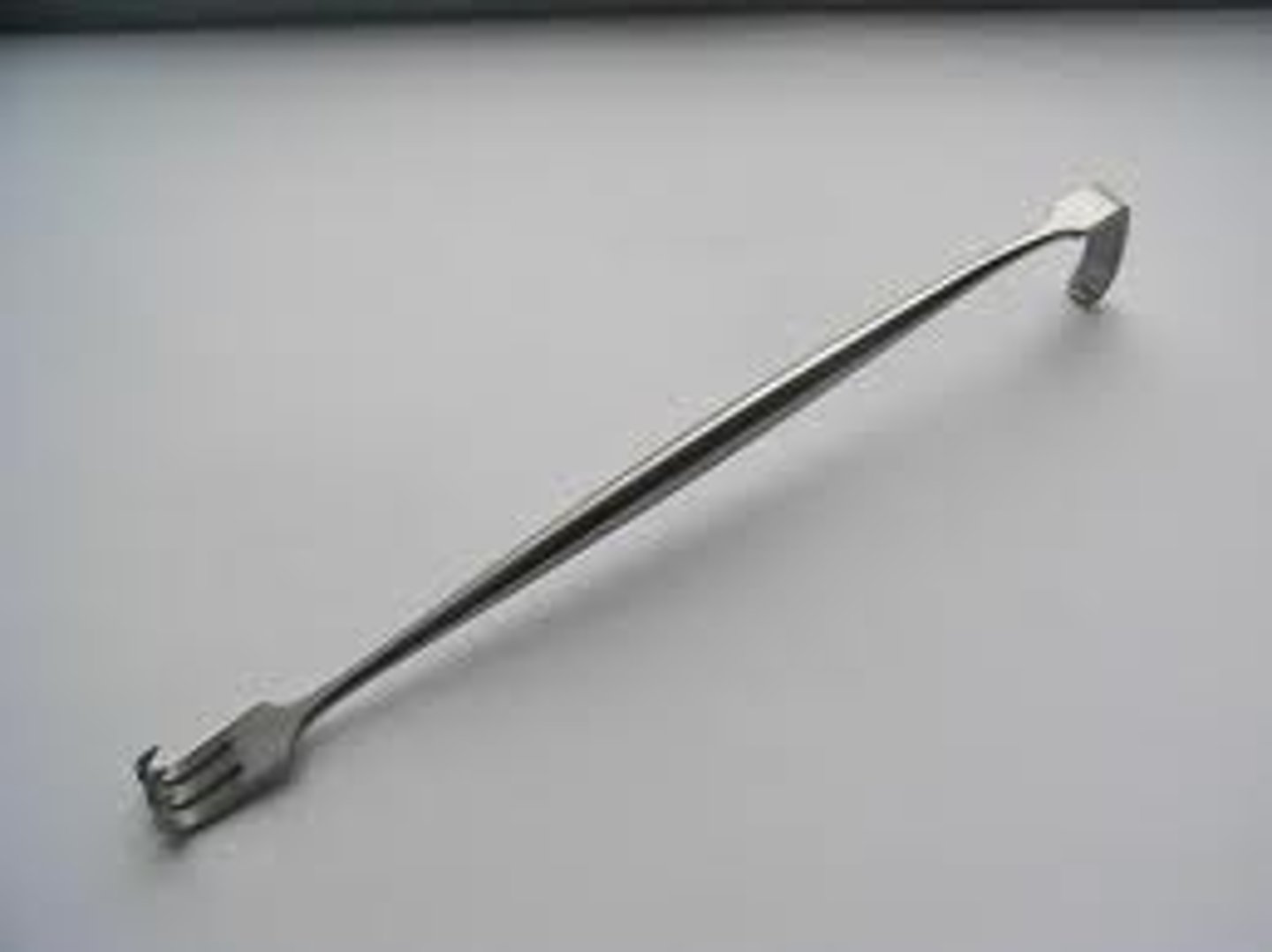 <p>A handheld instrument with a curled, three pronged claw at one end and a right-angled, single blade at the other. This is used to retract tissue layer on procedure involving hands, fingers, and small anatomy.</p>