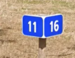 <p>kilometer marker at a 45 degree angle to the road</p>