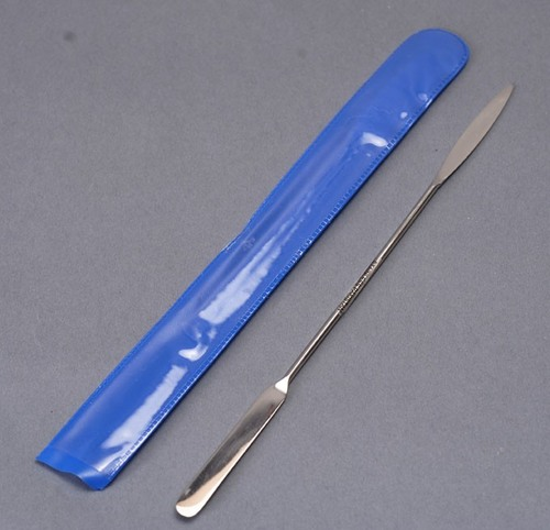 <p><span>Made of metal; has a flat rounded end and a rectangular end; used to transfer solid chemicals</span></p>