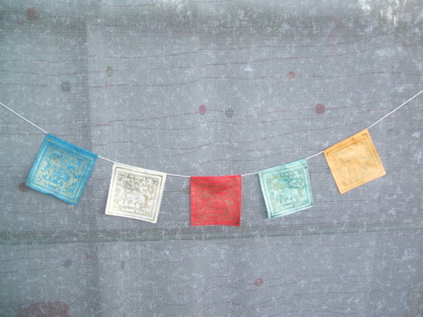 <p>Used in Tibetan Buddhism, these flags are often very colorful and have prayers inscribed on them; specific prayers bless specific things. (A prayer flag hung outside a house is meant to bless the house)</p>