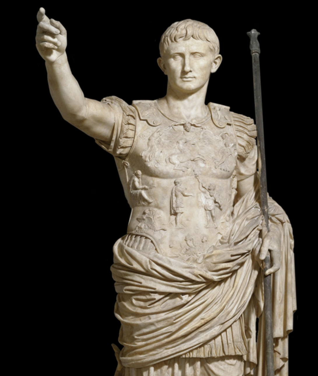 <p>In what way does this statue of Augustus draw from Ancient Greek statues like the Riace Warrior?</p><ul><li><p><span>The statue's military garb and cloak.</span></p></li><li><p><span>The statue's broad body proportions and musculature.</span></p></li><li><p><span>The position of Augustus' raised arm.</span></p></li><li><p>The true likeness of the Emperor Augustus' individual features.</p></li></ul><p></p>