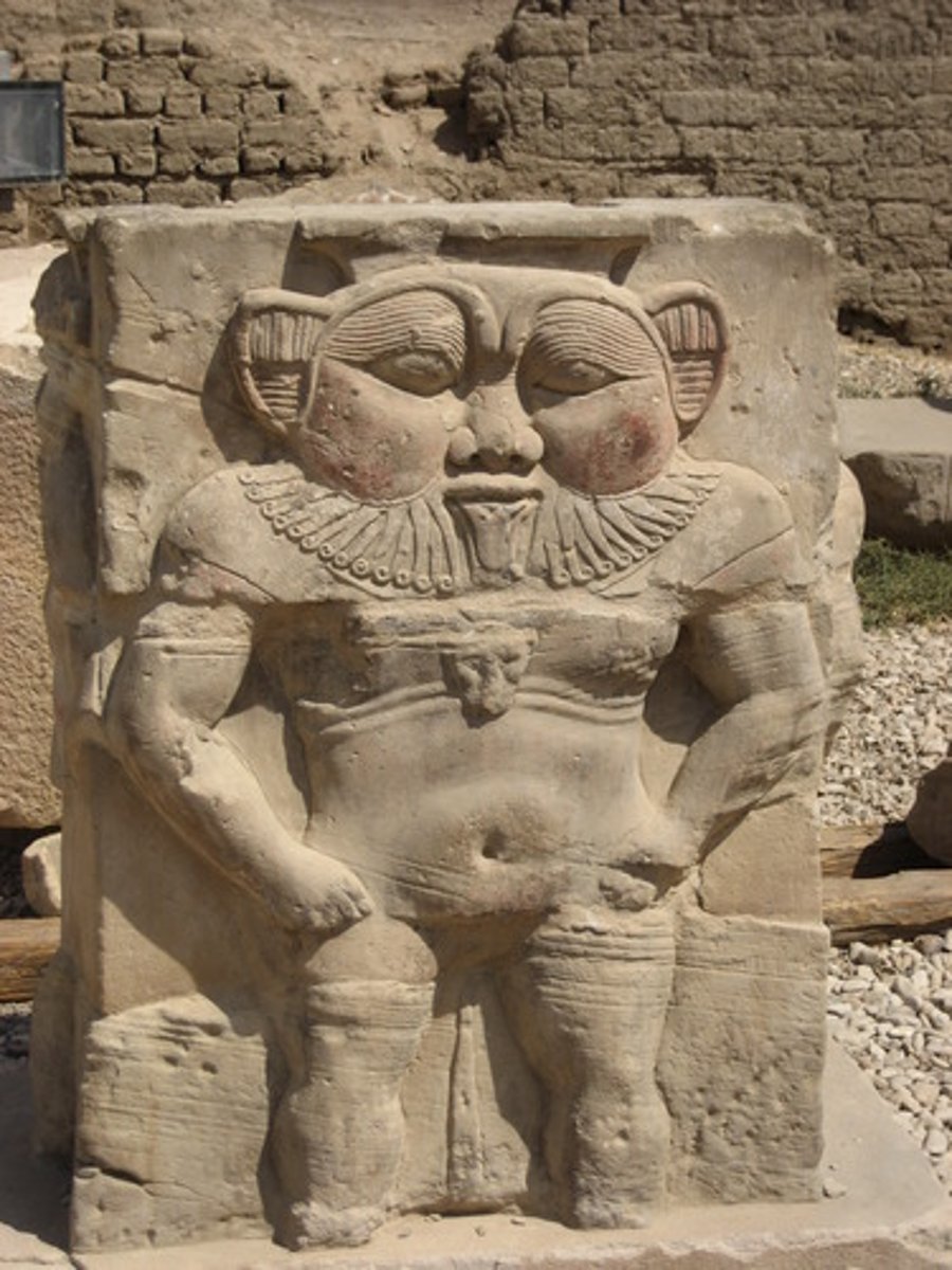 <p>-ancient Egyptian deity associated with protection, childbirth, and fertility, often depicted as a dwarf with a lion's mane and ears, wearing a feathered headdress and holding a tambourine or knife.</p><p>-He was a popular household deity worshipped for his ability to ward off evil spirits and bring good luck and prosperity.</p><p>-Bes was often depicted on amulets, household items, and protective charms, and his image was believed to guard against harm and malevolent forces.</p><p>-Despite his fearsome appearance, Bes was also considered a playful and jovial deity, bringing joy and laughter to those who invoked his protection.</p>