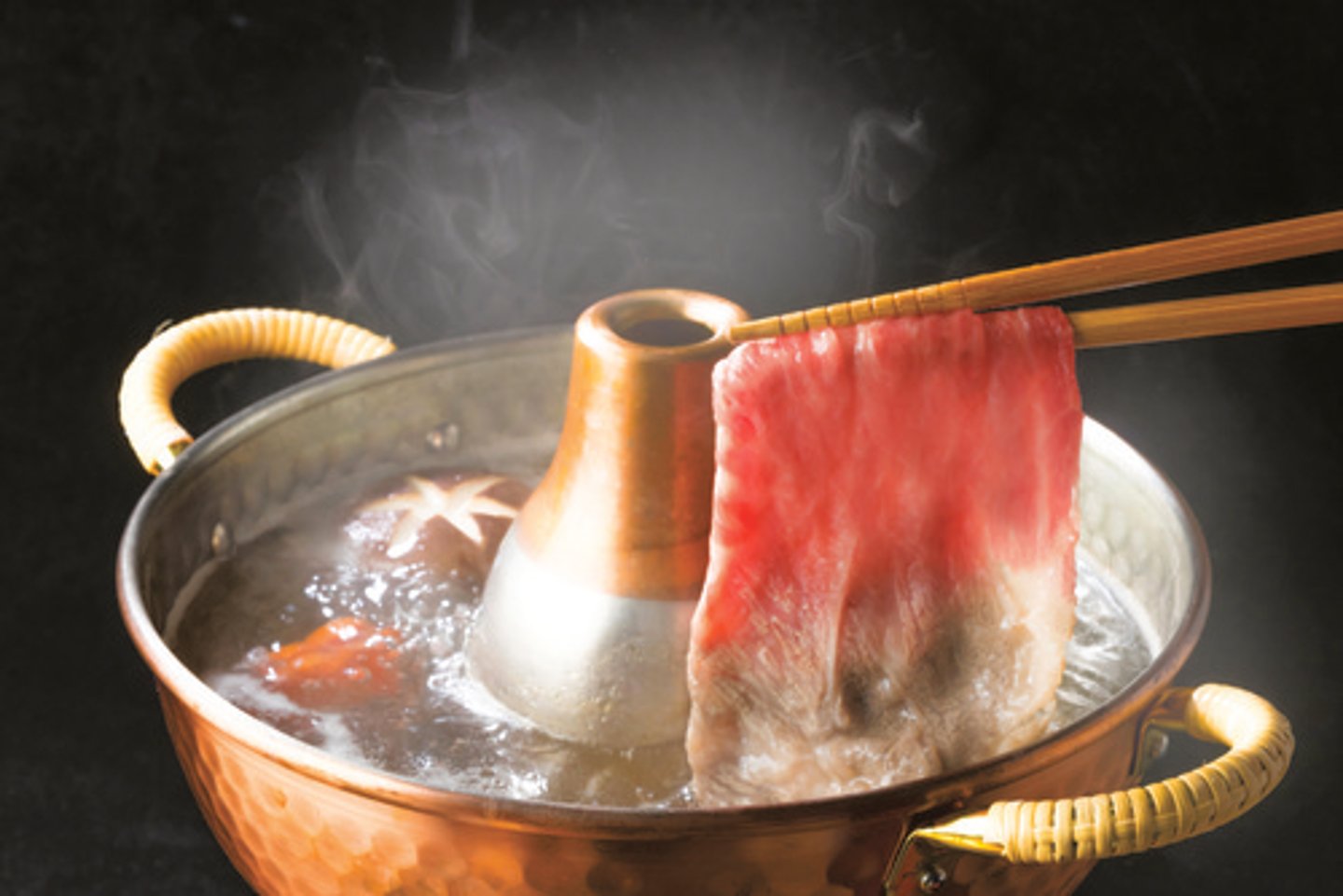 <p>beef cooked in stock with dipping sauce</p>