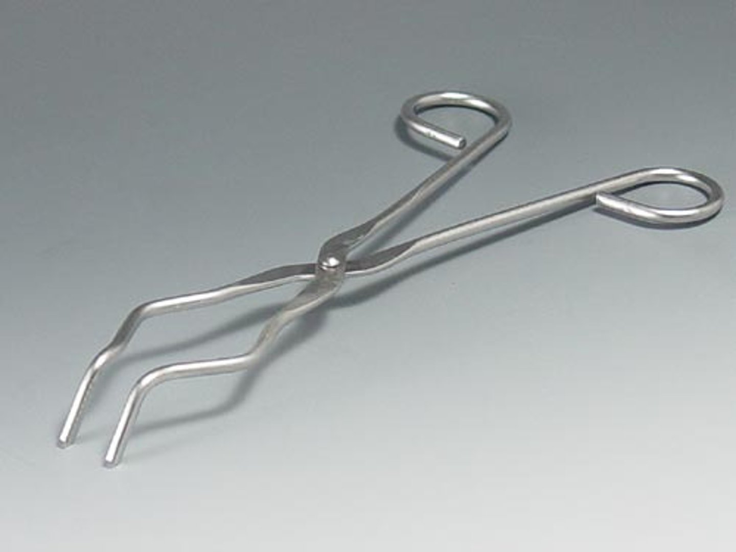 <p>Tongs with oval opening in jaws for holding crucibles; tips used for handling crucible covers</p>