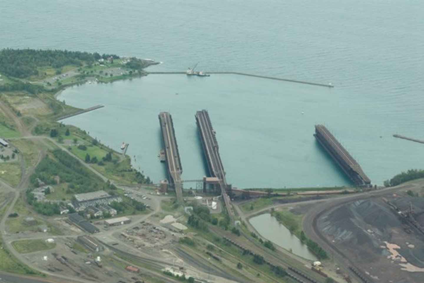 <p>A sheltered part of a body of water where ships can safely dock.</p>