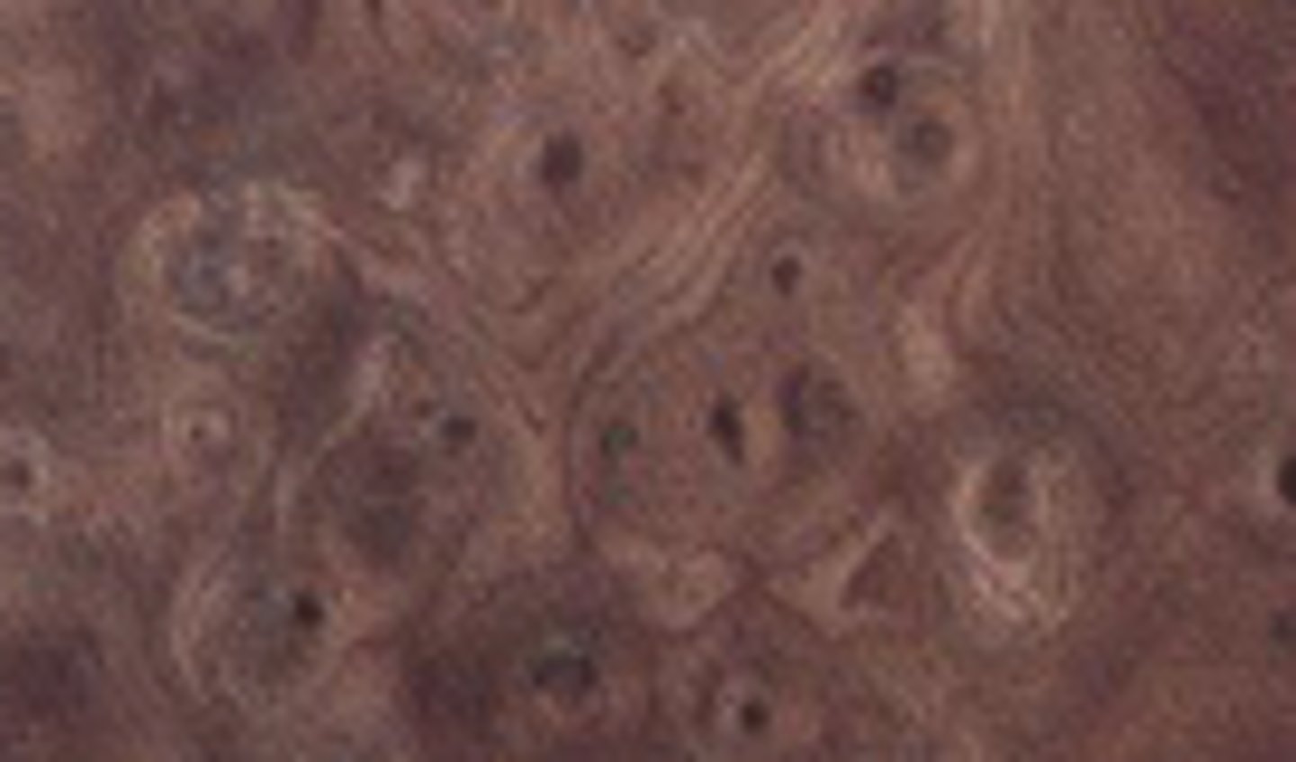 <p>Hardwood, with a swirling growth pattern used for veneers and inlays</p>