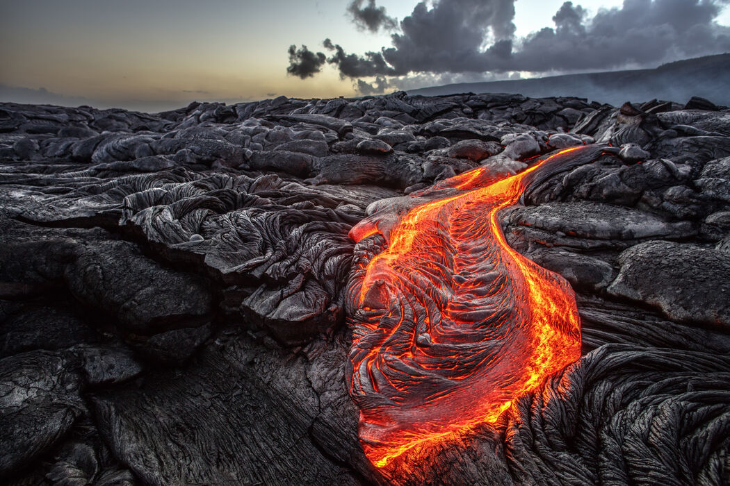 <p>A release of magma at the Earth&apos;s surface</p><p>The eruption of hot liquid rock forms natural hazards such as lava flows and ash clouds.</p>