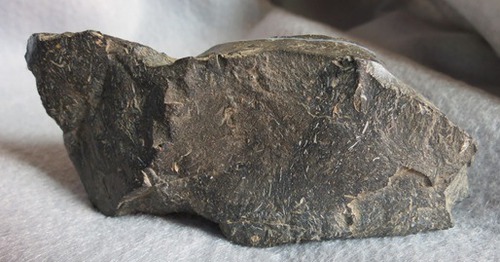 Luster: non-metallic
Hardness: 7
Breakage: conchoidal fracture
Streak: no streak
Color: dark grey or black