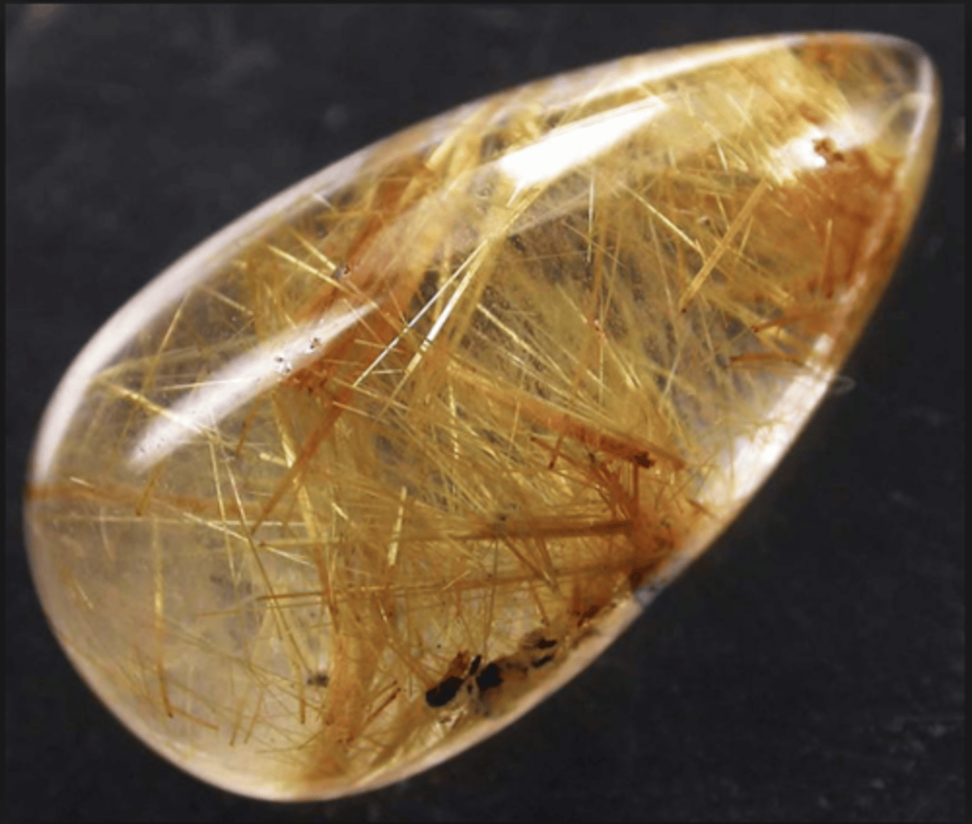 <p>A mineral with rutile shooting through it (rutilated quartz)</p>