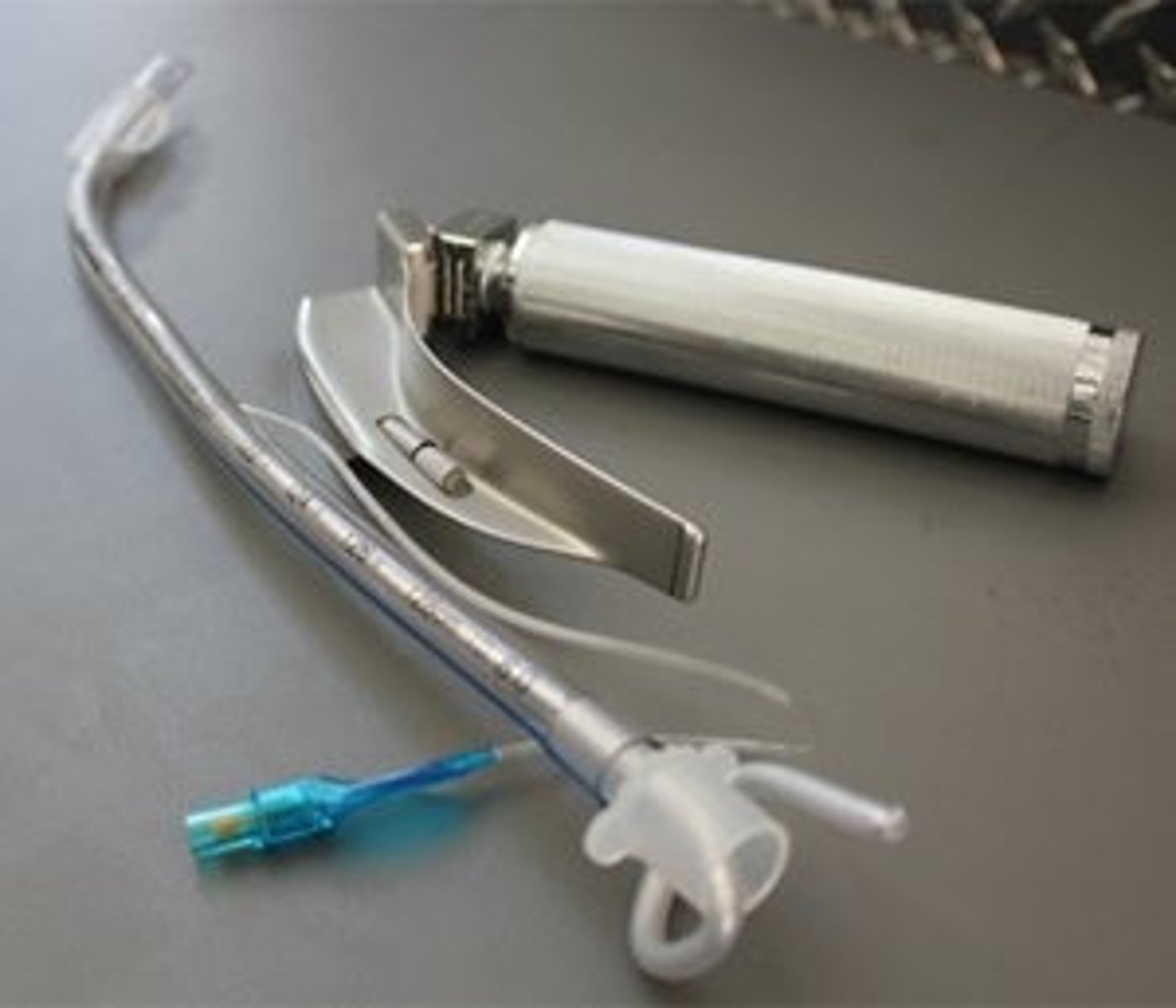 <p>a tool with a light that let’s doctors see the vocal cords, while a flexible tube is inersred in the trachea to keep airway open</p>