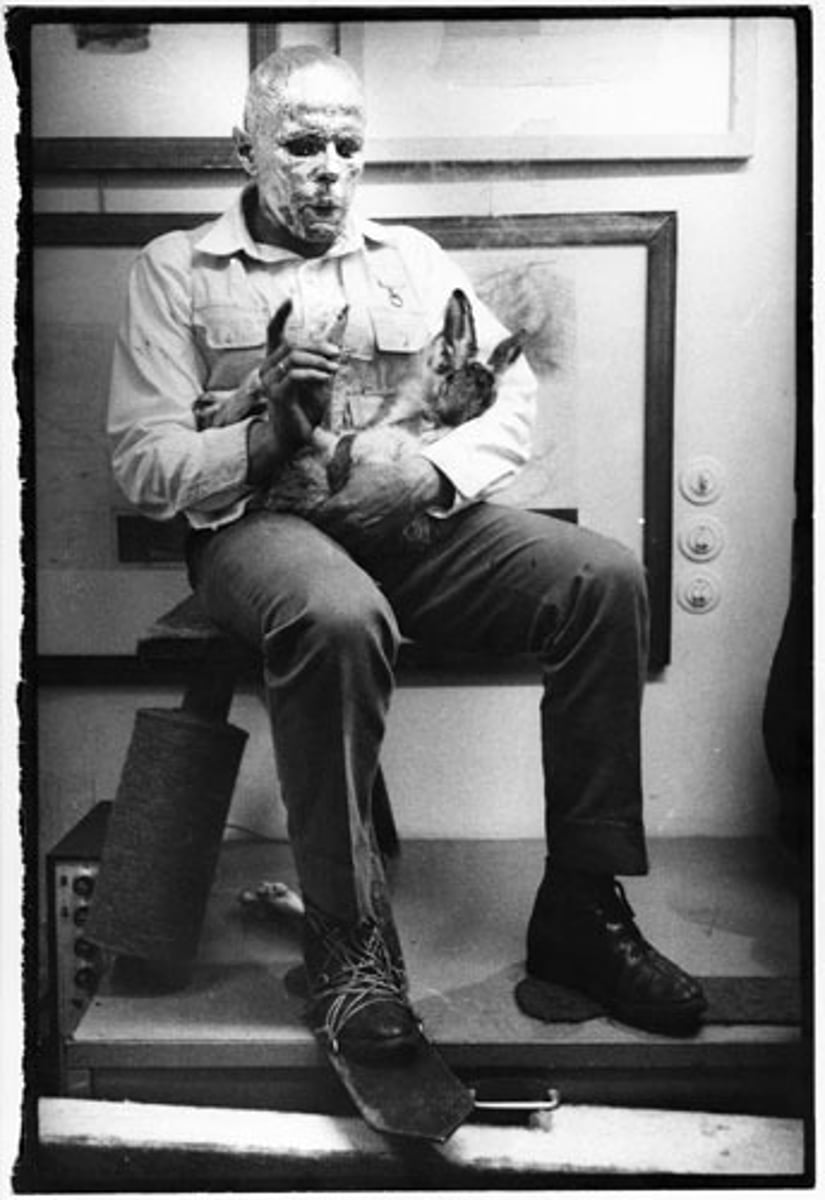 <p>Joseph Beuys</p><p>1965</p><p>performance</p><p>Notes: German artist who taught at the art school in Deusseldorf. Both an artist and a sculptor. Shot down as a pilot in the army. Wanted his art to change the world and lead them into a good spiritual life.</p><p>Commissioner:</p><p>Original Location:</p><p>Style: Performance Art.</p><p>Characteristics: Covered himself in honey and gold life. Carried a stuffed dead hair. Went around the room and explained his drawings to a dead hare. Sat on a stool that was wrapped in felt. Held the hare in his hand. Honey is symbolic in Germanic culture — bees capacity to create honey like the artists capacity to create. Gold like the sun.</p><p>Subject:</p><p>Function: Personal symbolism.</p>