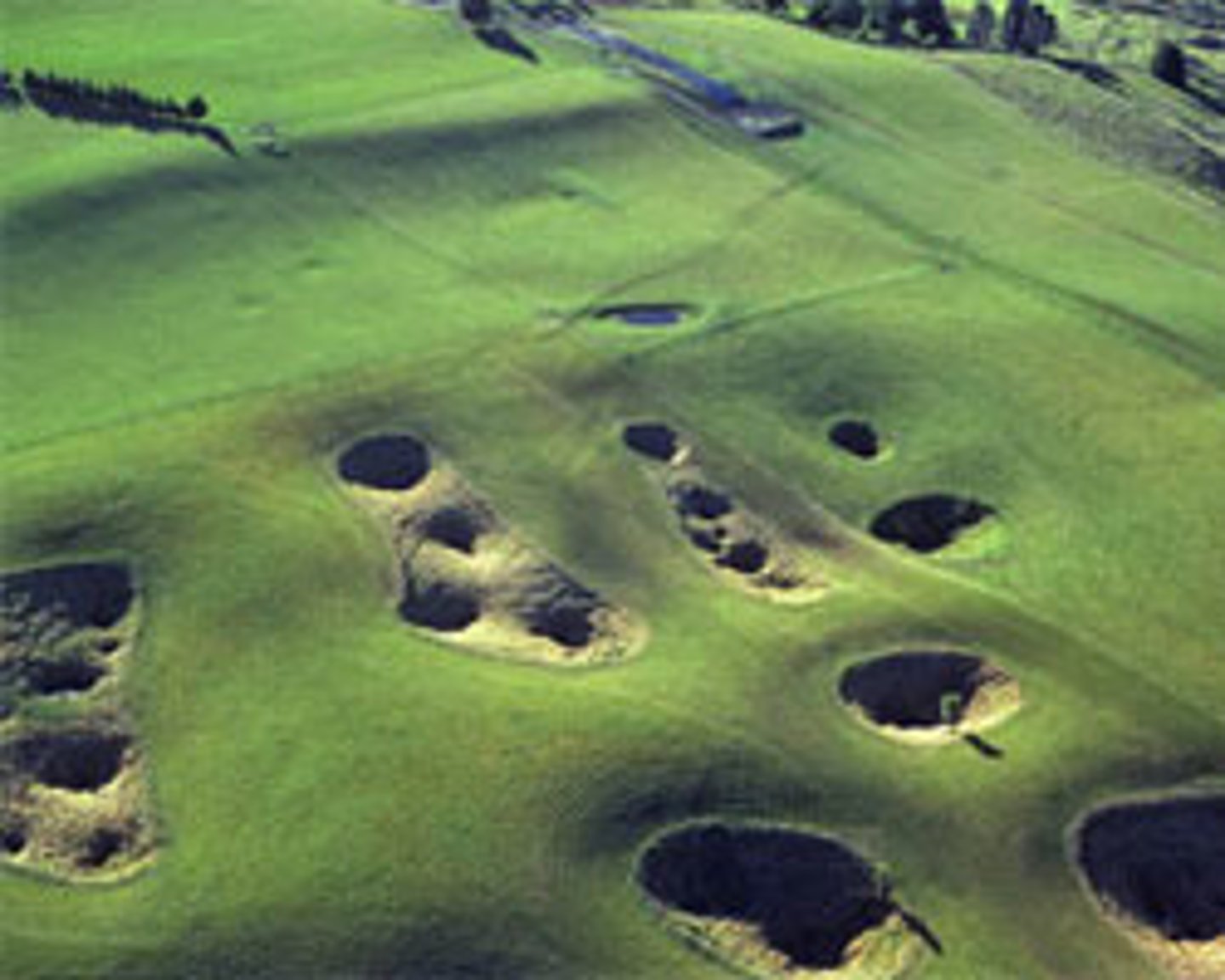 <p>surface landscape formed by rock dissolving at or near the surface. Includes sinkholes, sinking streams, caverns, towers, fissures and other landforms</p>