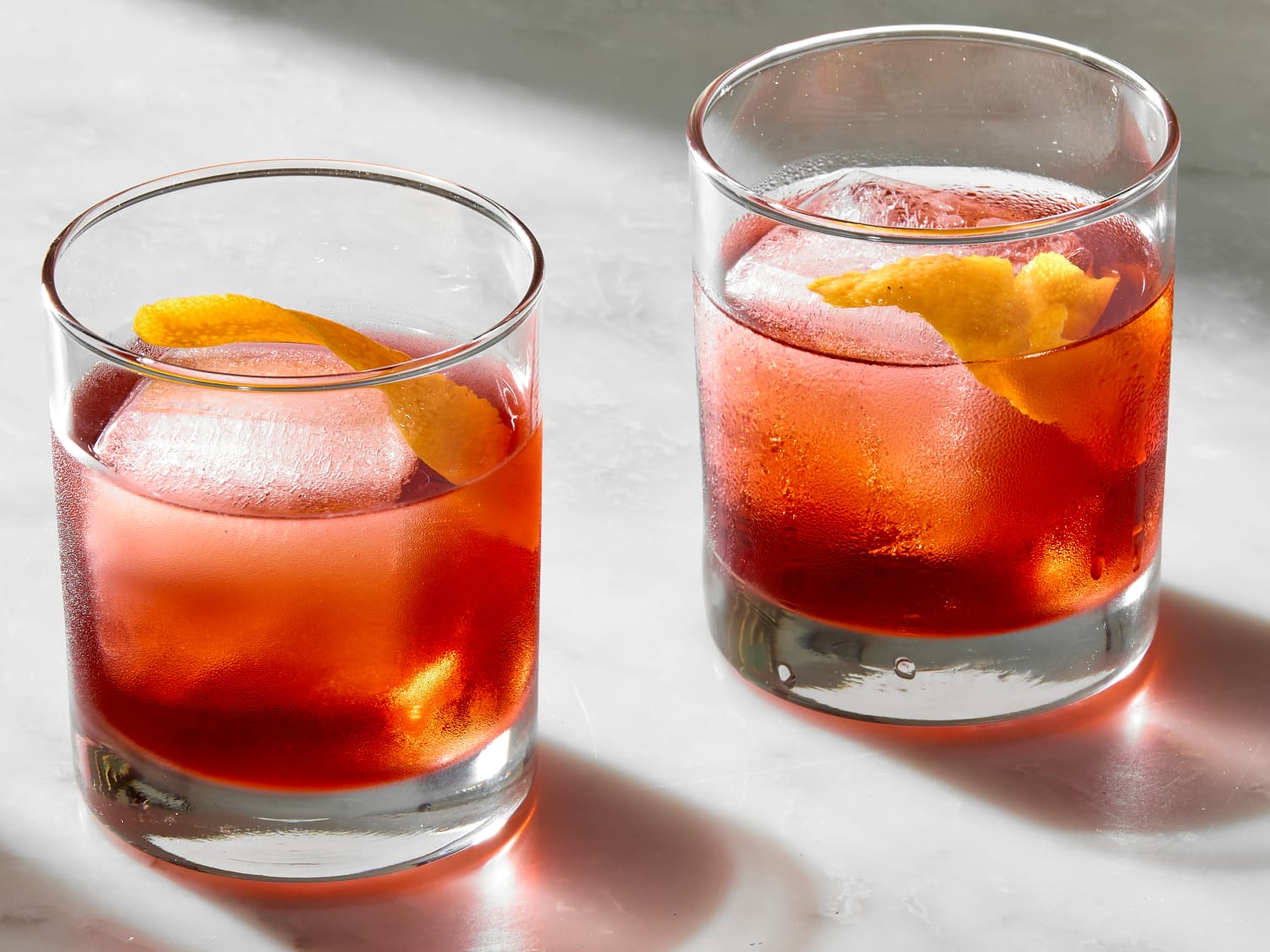 <p>negroni, 1 oz gin, 1 oz sweet vermouth, 1 oz Campari, served on the rocks, garnish orange peel</p>