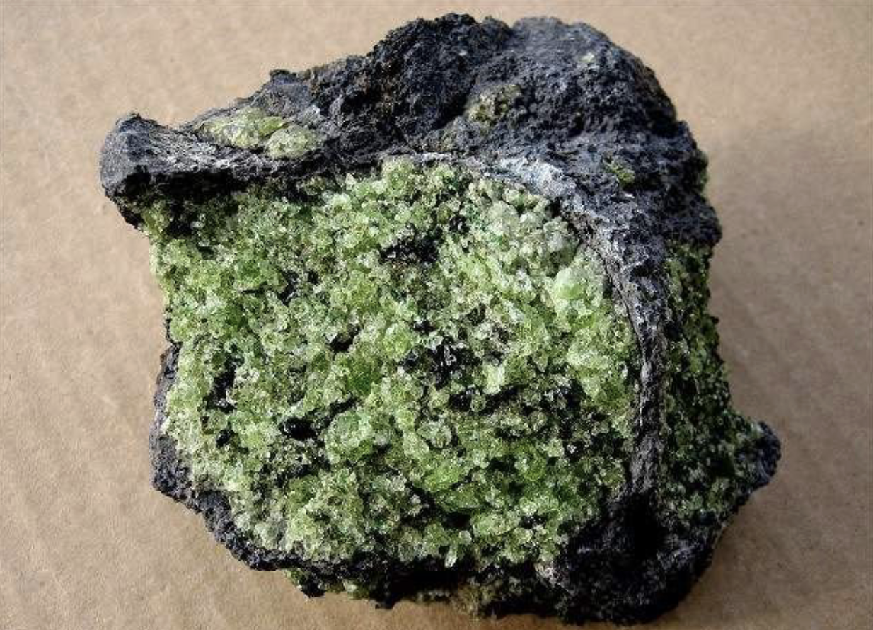 <p>Usually green, first to crystallize out of a melt</p>