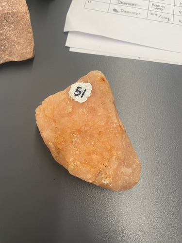 <ul><li><p>Pink/orange</p></li><li><p>reacts with acid</p></li><li><p>Large crystal grains </p></li></ul>