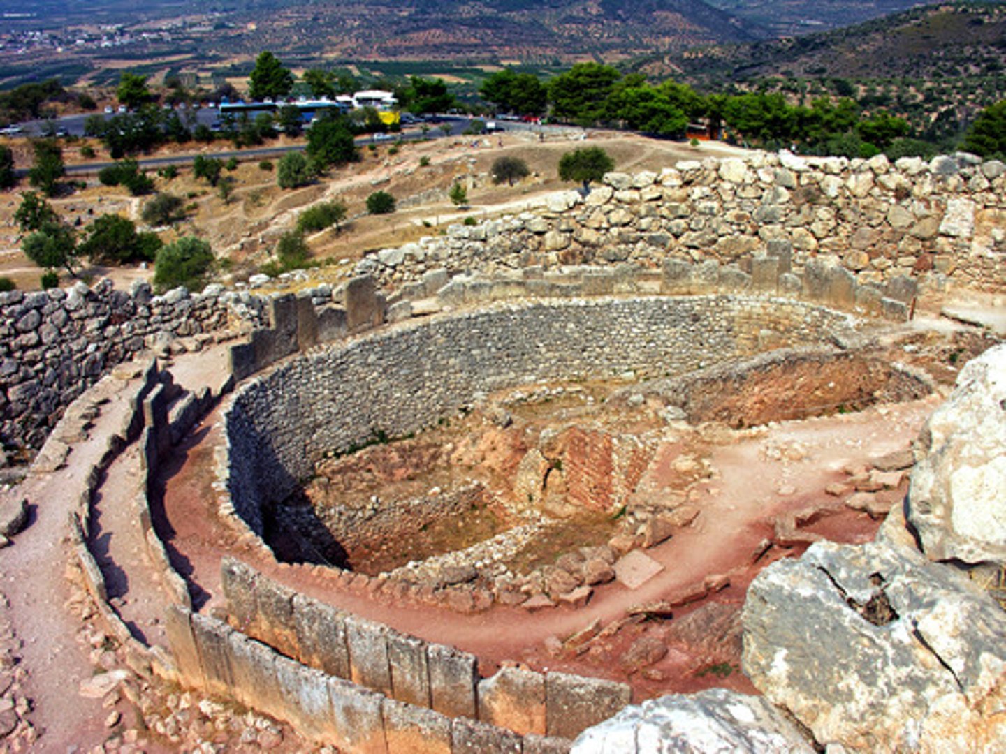 <p>Who:</p><p>The graves were those of royal or leading Greek families1.</p><p>What:</p><p>The Shaft Graves are late Bronze Age (c. 1600-1450 BC) burial sites1. They contain a wealth of objects, including gold masks, weapons, and ornaments2.</p><p>Where:</p><p>The Shaft Graves are located in the Mycenaean citadel at Mycenae2.</p><p>Original Findspot:</p><p>The graves are located at their original site in Mycenae2.</p><p>When:</p><p>The graves date back to the Late Bronze Age (1550-1200 BC)2.</p><p>Why it's interesting and important:</p><p>The Shaft Graves at Mycenae signify the elevation of a local Greek-speaking royal dynasty whose economic power depended on long-distance sea trade3. (<span>Agamemnon) </span> The graves were unplundered and undisturbed until found by modern archaeologists at Mycenae1. The wealth of objects found in the graves has shed light on the city's culture and customs2.</p>