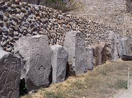 <p>Middle Formative. Carved on stone slabs, they were thought to be figures dancing/appear to be figures dancing. They may be sacrificed captives of war “trapped” within the slabs. 300+ slabs were carved with these figures and 140 were incorporated into what we call Temple of the Danzantes. 140 in Mound J. Others reused as stones for building</p>